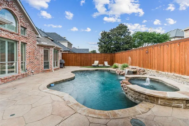 a view of a backyard with swimming pool