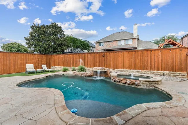 a view of a backyard with swimming pool