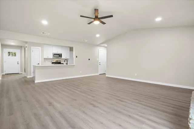 a view of a kitchen with a sink and a stove wooden floor