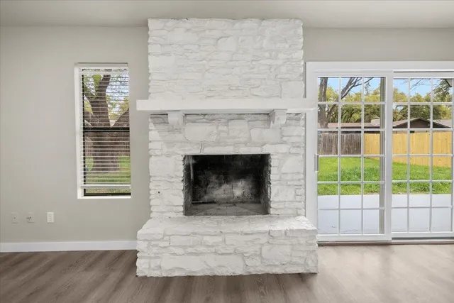 a living room with a fireplace and a large window