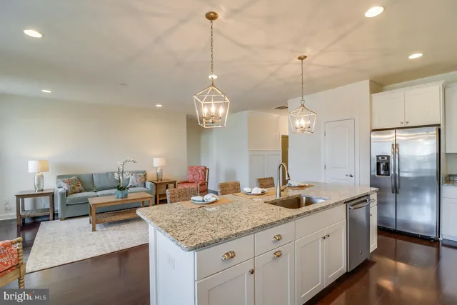 a bathroom with a granite countertop tub sink toilet and mirror