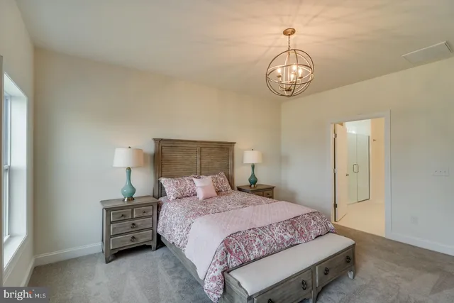 a bedroom with furniture and a large window