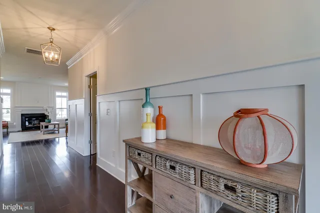 a living room with furniture fireplace and large windows
