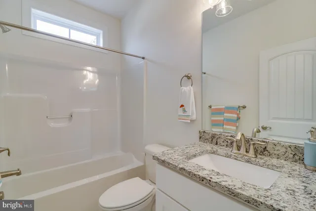 a kitchen with stainless steel appliances granite countertop a sink a stove a dining table and chairs