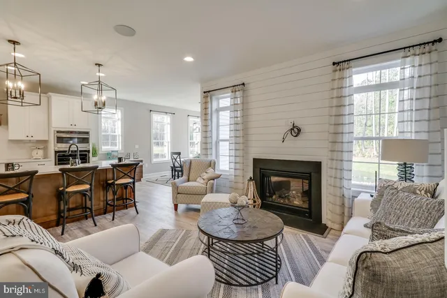 a bathroom with a sink a toilet and a large mirror