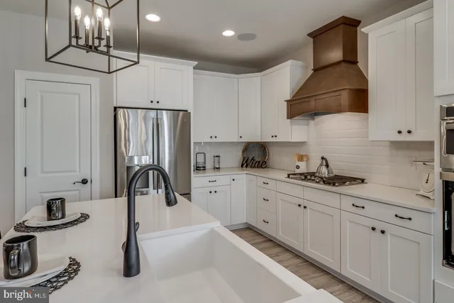 a kitchen with stainless steel appliances granite countertop a stove refrigerator sink and microwave