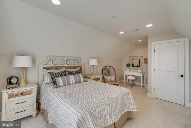 a large kitchen with stainless steel appliances a large counter top a stove a refrigerator and a sink