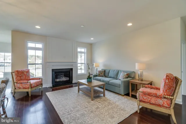 a living room with stainless steel appliances furniture or fireplace and a wooden floor
