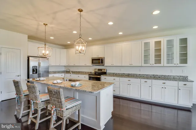 a view of a dining room with furniture a chandelier and wooden floor