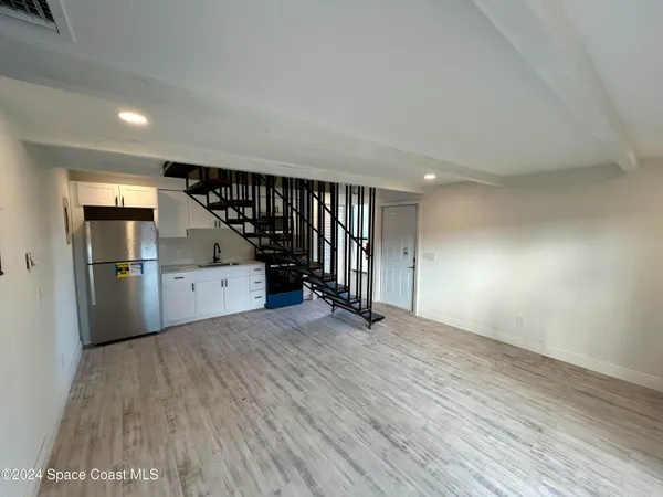 a view of a kitchen with a sink and cabinets