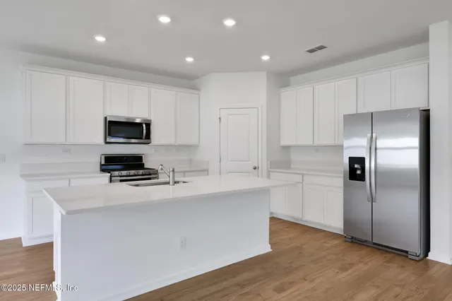 a kitchen with a stove and a microwave