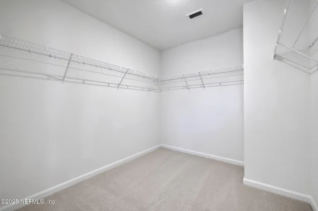 a bathroom with double sink and a mirror