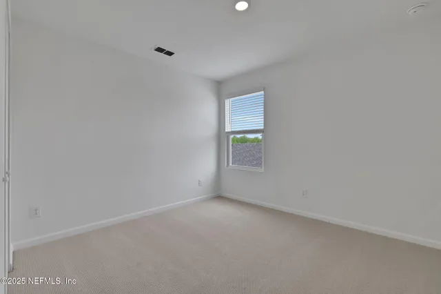 a bathroom with a double vanity sink a toilet and a mirror