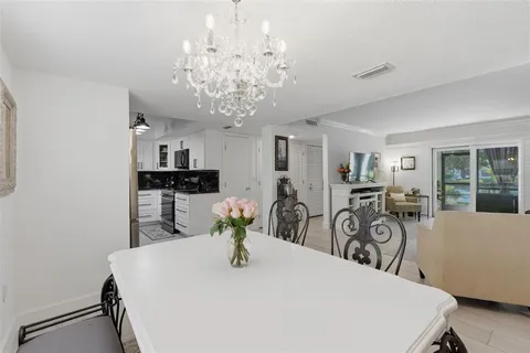 a kitchen with white cabinets and appliances