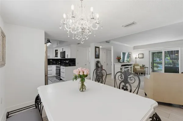 a kitchen with white cabinets and appliances