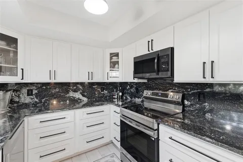 a kitchen with stove and cabinets