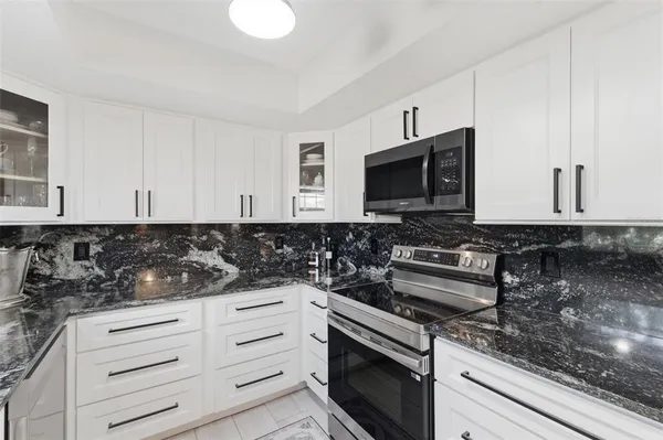 a kitchen with stove and cabinets