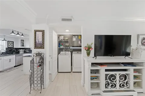 a bedroom with a bed and a large mirror on dresser next to a window