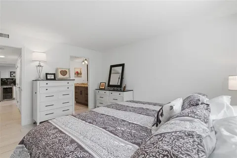 a bedroom with a dresser and a mirror