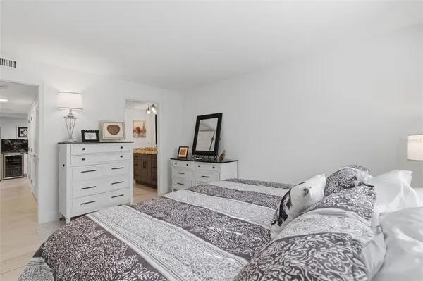 a bedroom with a dresser and a mirror