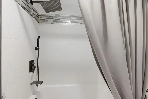 a bathroom with a granite countertop sink a mirror and a shower