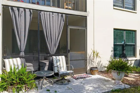 a view of a house with backyard and sitting area