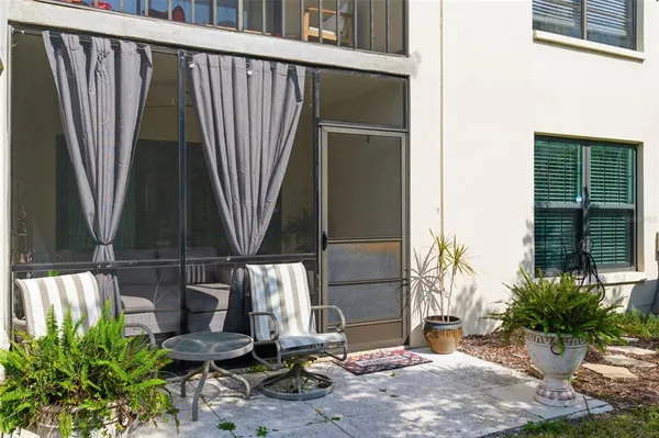 a view of a house with backyard and sitting area