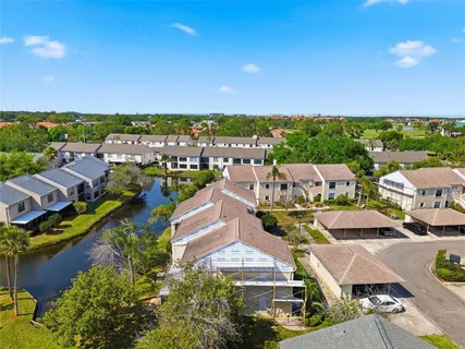 an aerial view of residential houses with outdoor space and street view