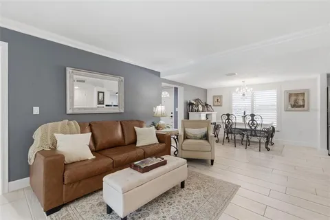 a view of a dining room with furniture and a chandelier