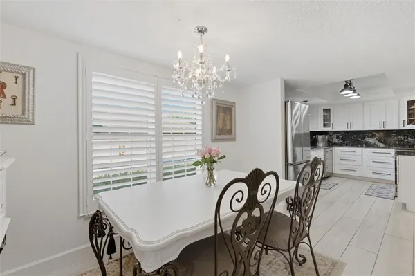 a view of a dining room with furniture and chandelier
