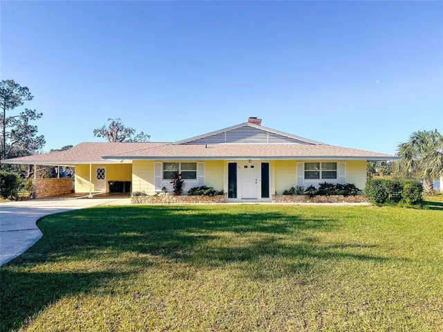 a front view of a house with swimming pool having outdoor seating