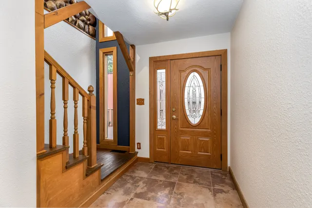 a view of a hallway with elevator with wooden floor