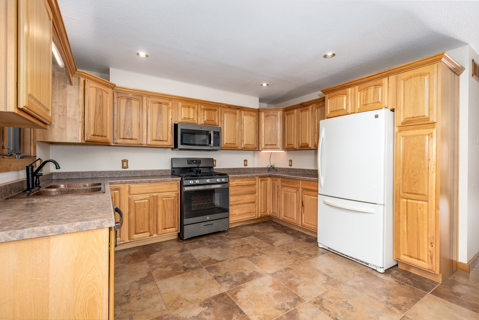 1522 East State Route 71 Ottawa, IL 61350 - Photo 10 of 35 a kitchen with granite countertop a refrigerator stove top oven a sink and dishwasher