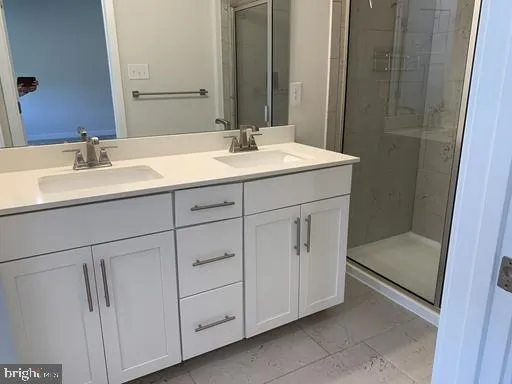 a bathroom with a shower sink and mirror