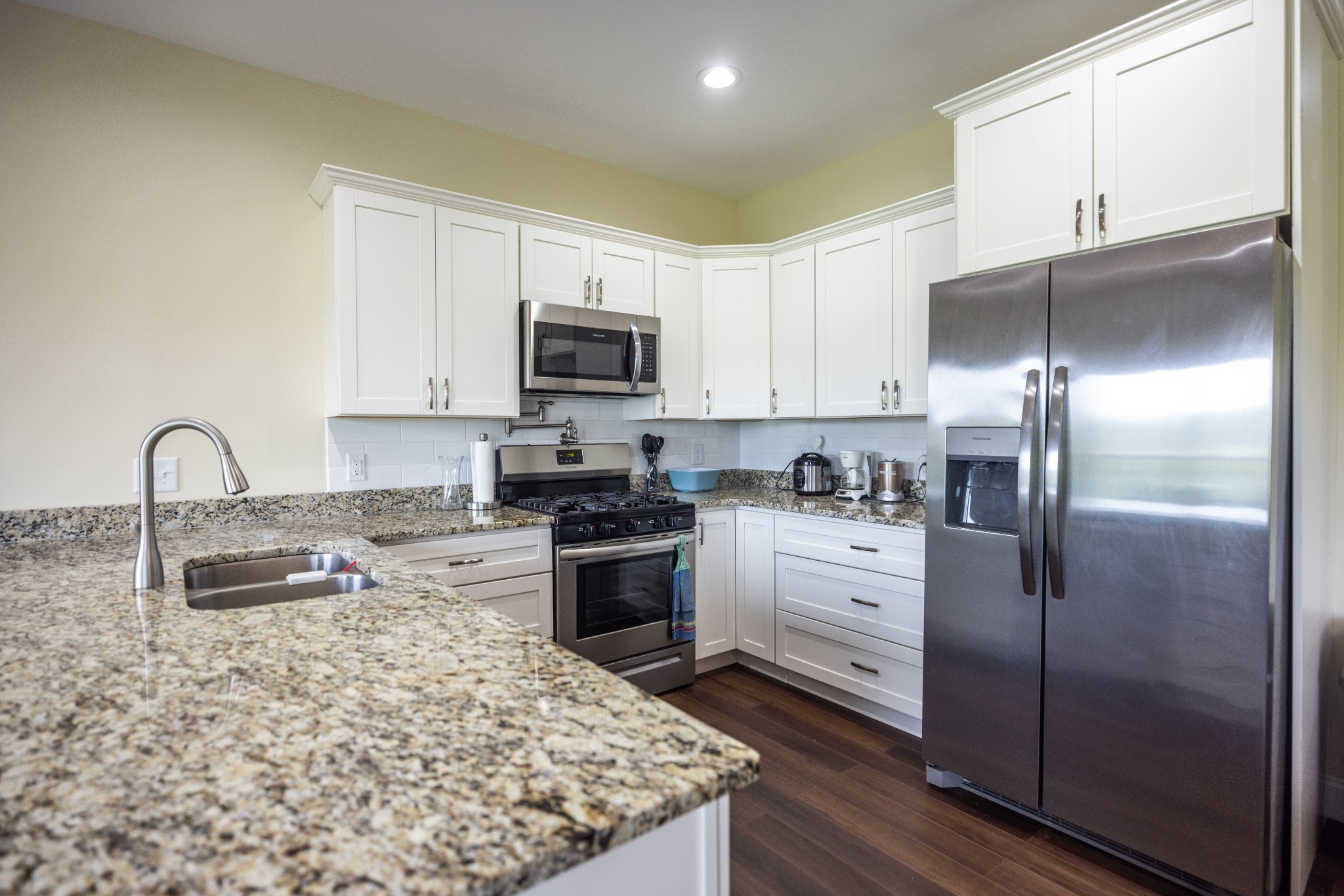 155 Colonial Road Hohenwald, TN 38462 - Photo 15 of 36 a kitchen with stainless steel appliances granite countertop a refrigerator a stove a sink and a microwave
