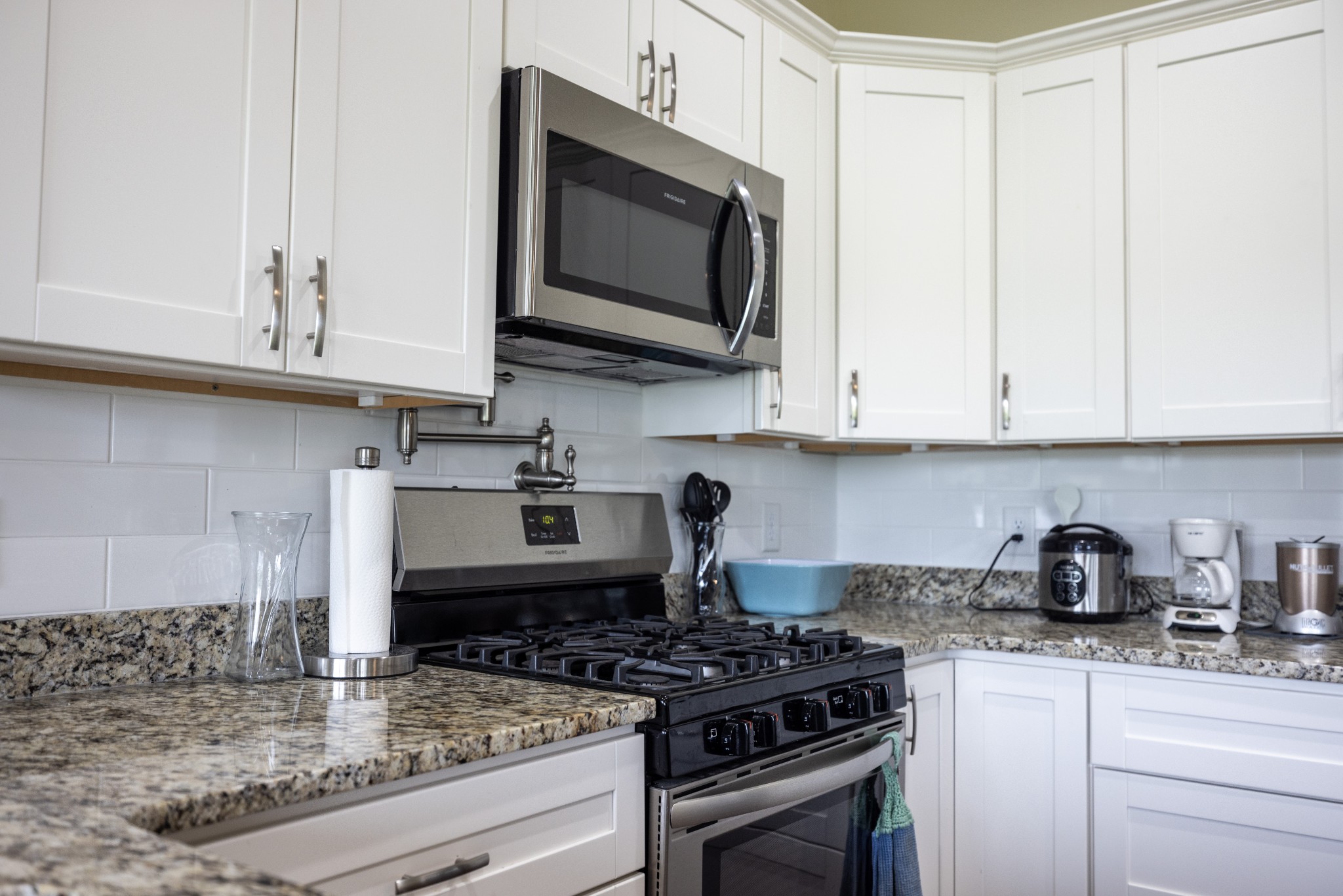 155 Colonial Road Hohenwald, TN 38462 - Photo 16 of 36 a kitchen with stainless steel appliances granite countertop a stove a microwave and cabinets