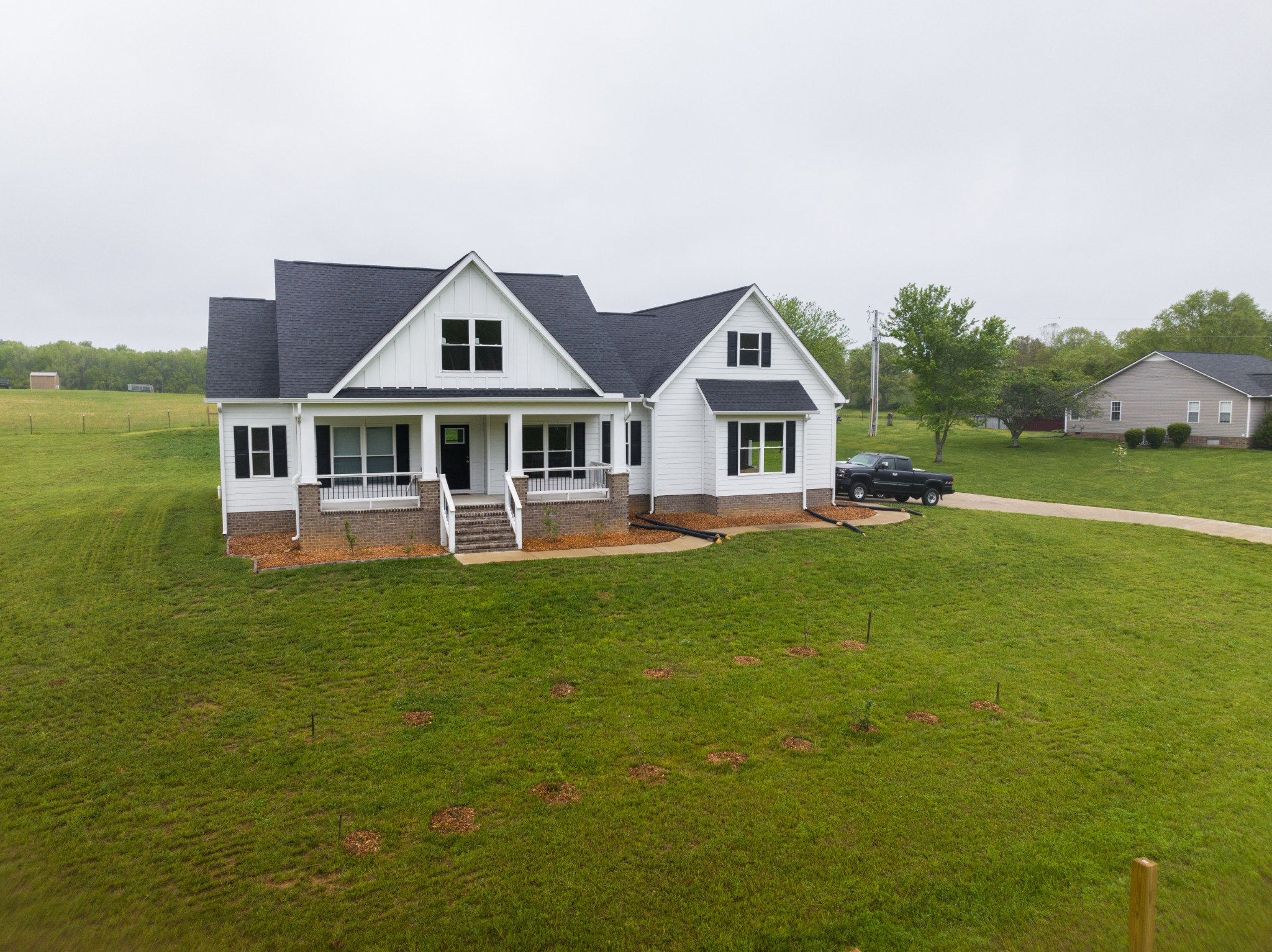 155 Colonial Road Hohenwald, TN 38462 - Photo 2 of 36 a front view of a house with garden