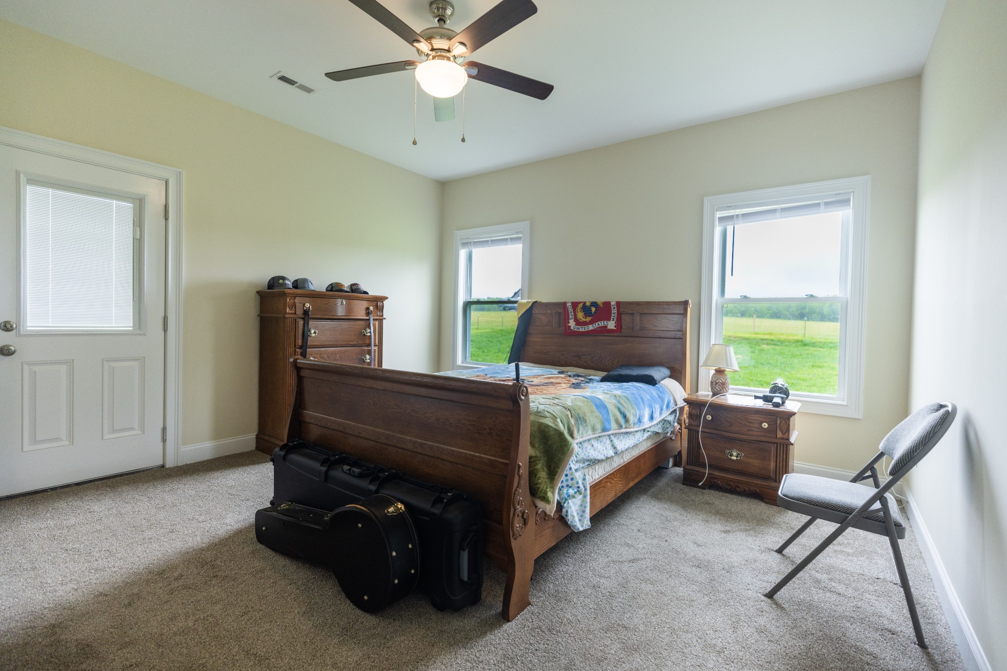 155 Colonial Road Hohenwald, TN 38462 - Photo 21 of 36 a bedroom with a bed and a chandelier