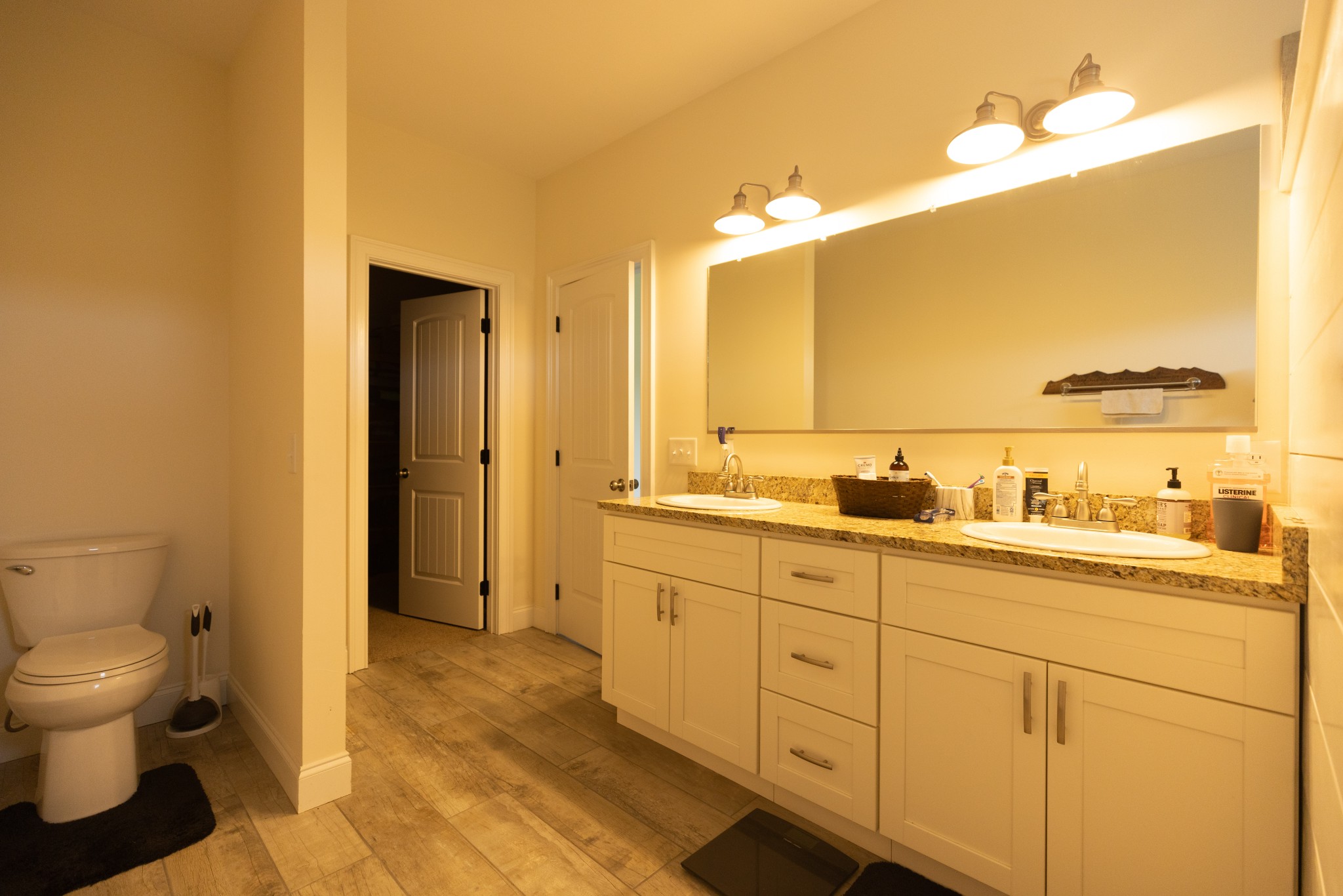 155 Colonial Road Hohenwald, TN 38462 - Photo 22 of 36 a spacious bathroom with a granite countertop sink mirror and toilet