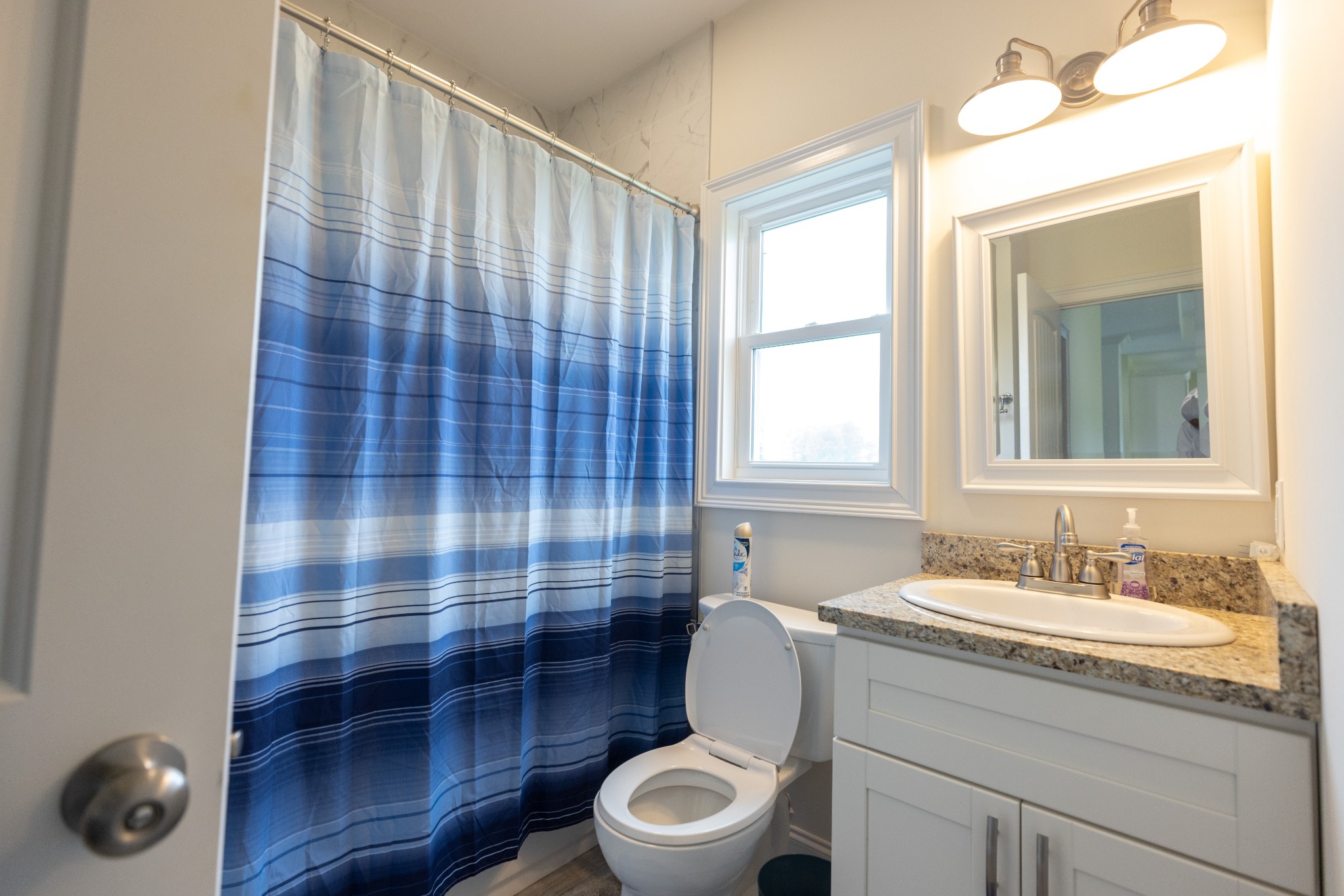 155 Colonial Road Hohenwald, TN 38462 - Photo 25 of 36 a bathroom with a sink a toilet a mirror and shower