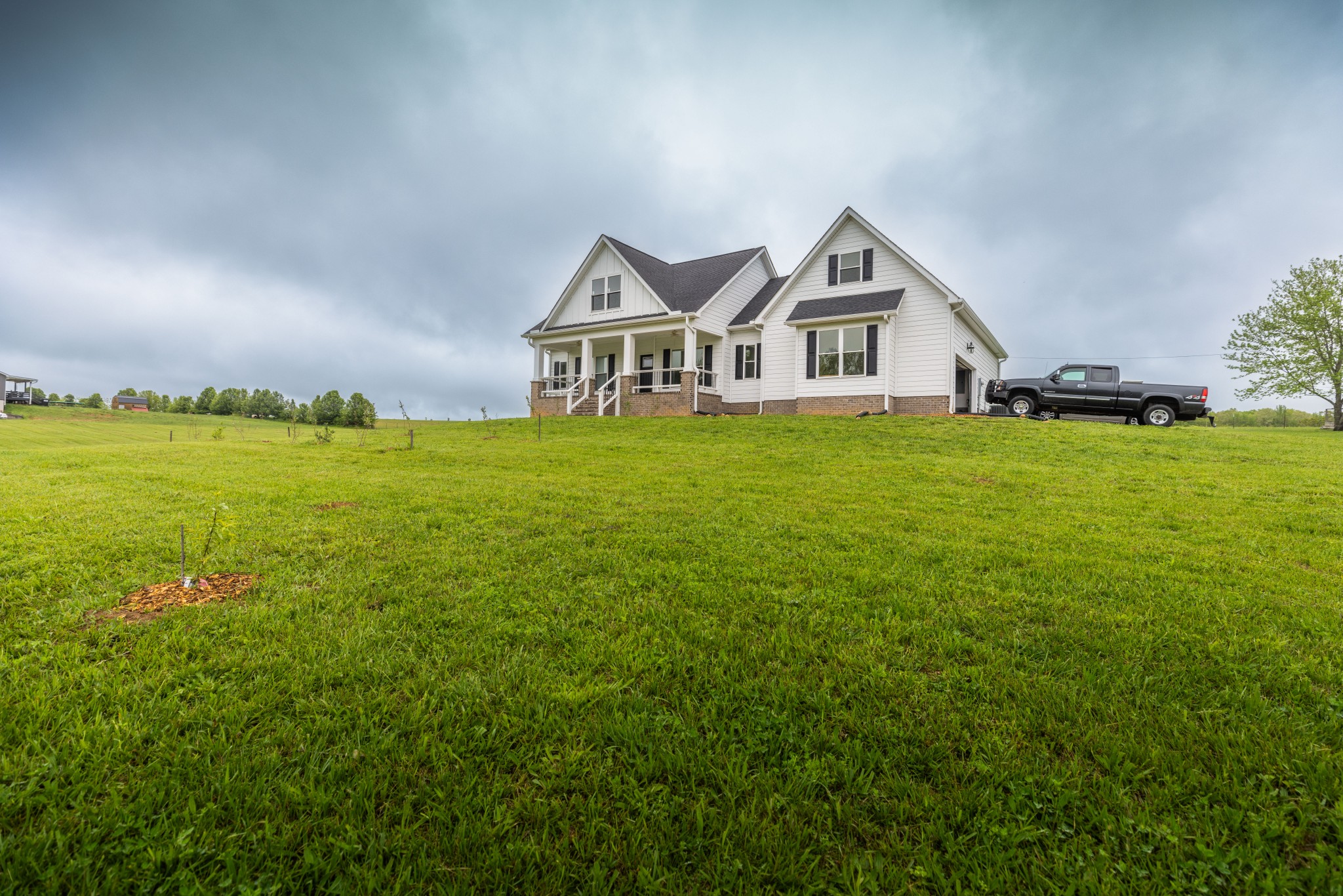 155 Colonial Road Hohenwald, TN 38462 - Photo 32 of 36 a front view of a house with a garden