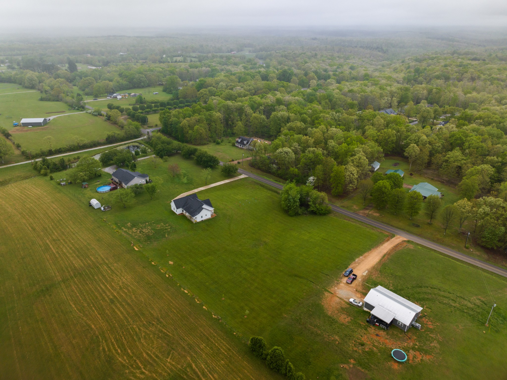 155 Colonial Road Hohenwald, TN 38462 - Photo 8 of 36 an aerial view of residential houses with outdoor space and trees