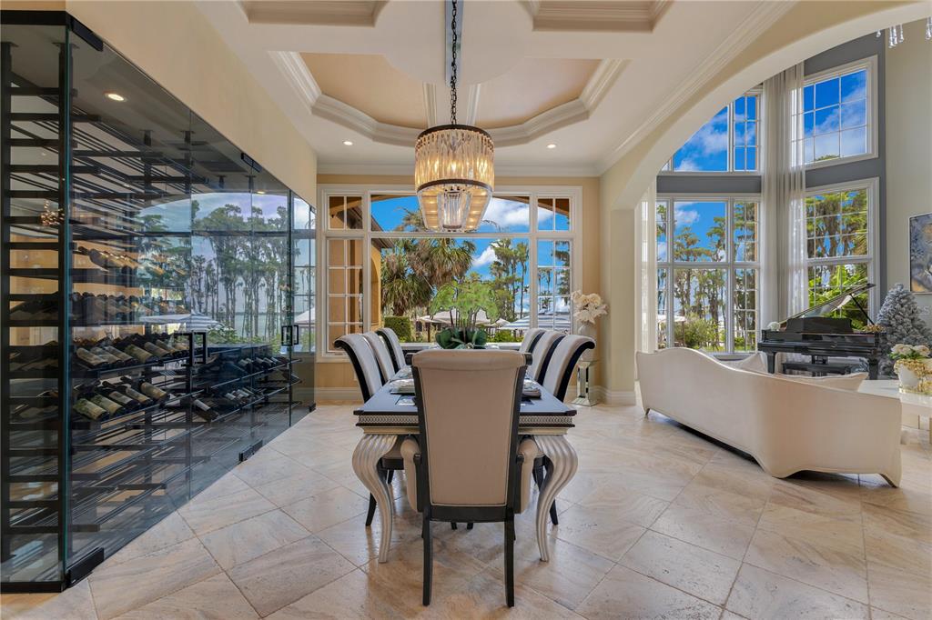 11103 Bridge House Road Windermere, FL 34786 - Photo 16 of 90 a dining room with furniture a chandelier and window