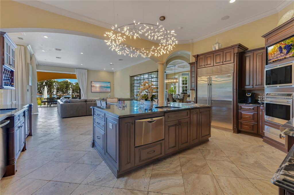 11103 Bridge House Road Windermere, FL 34786 - Photo 21 of 90 a kitchen with stainless steel appliances granite countertop a stove top oven a sink dishwasher and a refrigerator