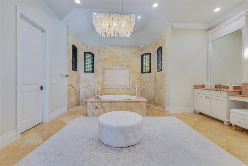 11103 Bridge House Road Windermere, FL 34786 - Photo 38 of 90 a bathroom with a sink a mirror and a bathtub