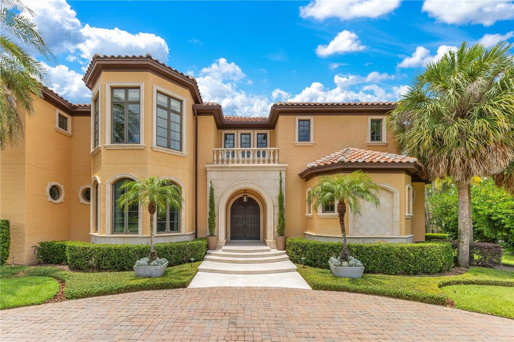 11103 Bridge House Road Windermere, FL 34786 - Photo 5 of 90 a front view of a house with a garden