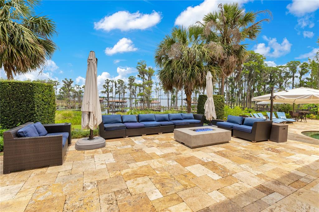 11103 Bridge House Road Windermere, FL 34786 - Photo 76 of 90 a view of a swimming pool with couches and lounge chairs