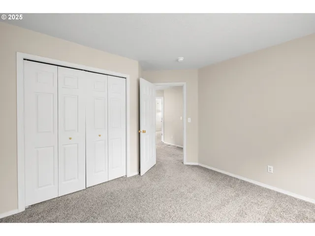 a view of an empty room and a bathroom