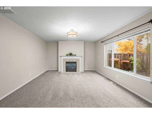 a view of empty room with a fireplace