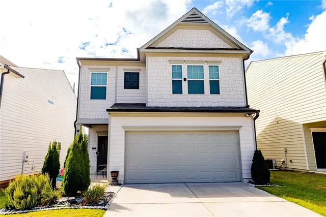a front view of a house with garden